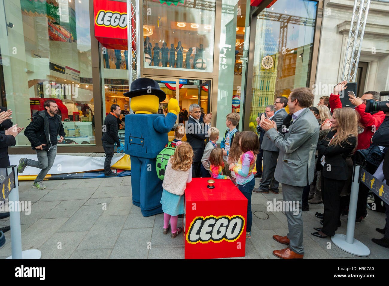 London, UK  17 November 2016. (L to R) Lego mascot, 'Lester', Sadiq Khan, local schoolchildren and Lego UK CFO. The world's largest Lego store is opened by Sadiq Khan, Mayor of London, in Leicester Square.  Huge crowds gathered for the opening and many Lego fans were able to buy exclusive pieces.  Credit:  Stephen Chung / Alamy Live News Stock Photo
