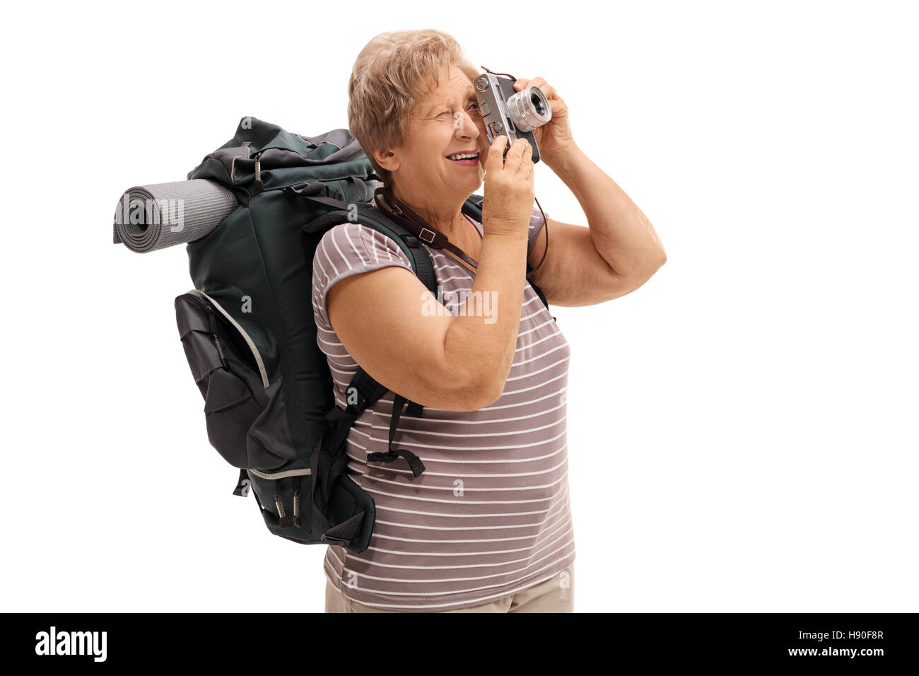 Senior hiker taking a picture with a camera isolated on white background Stock Photo