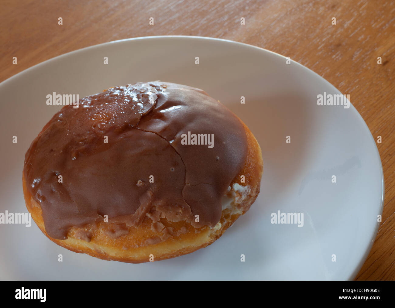 Chocolate covered donut that has a creme filling Stock Photo Alamy