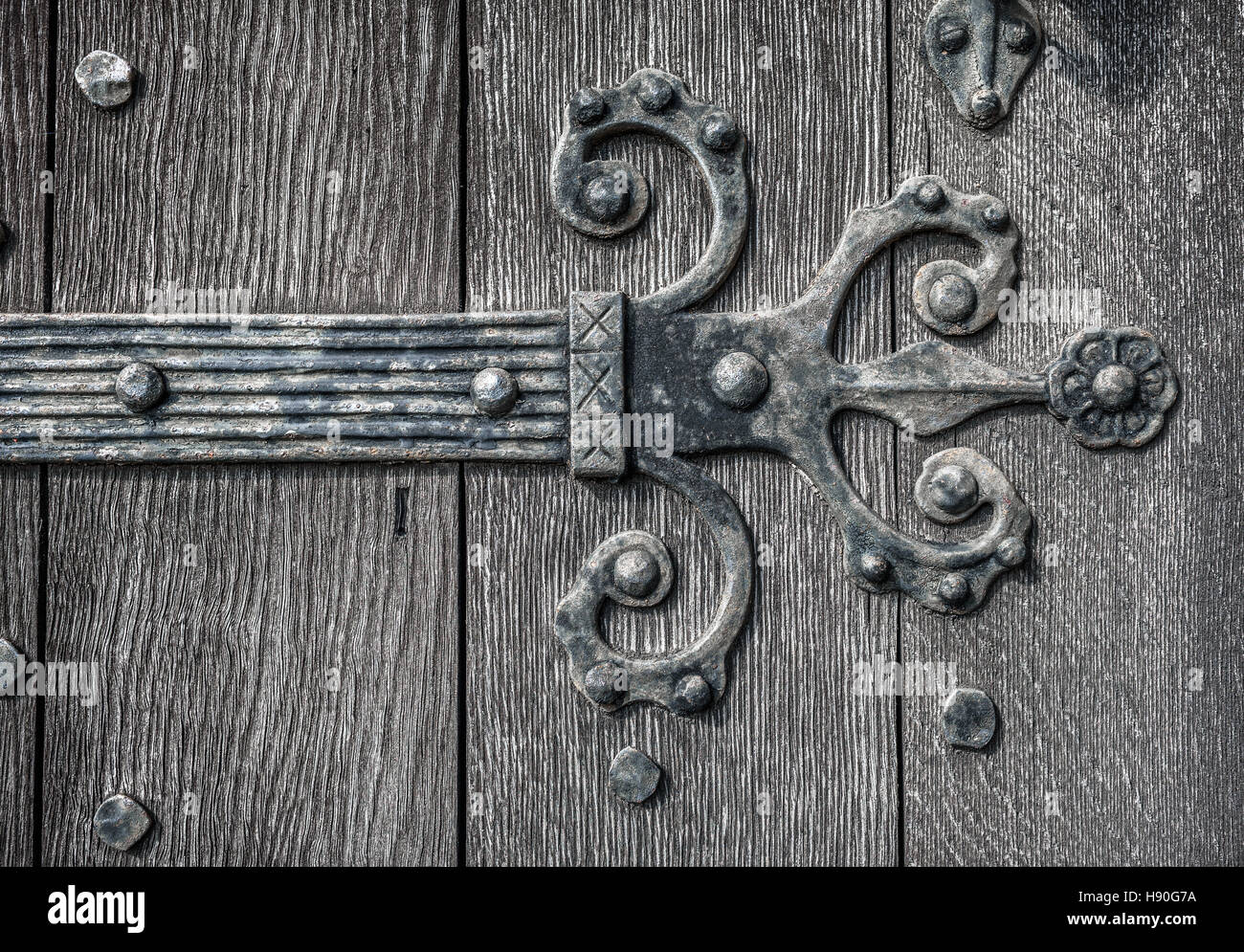 Ornate and weathered medieval church door hinge pattern Stock Photo Alamy