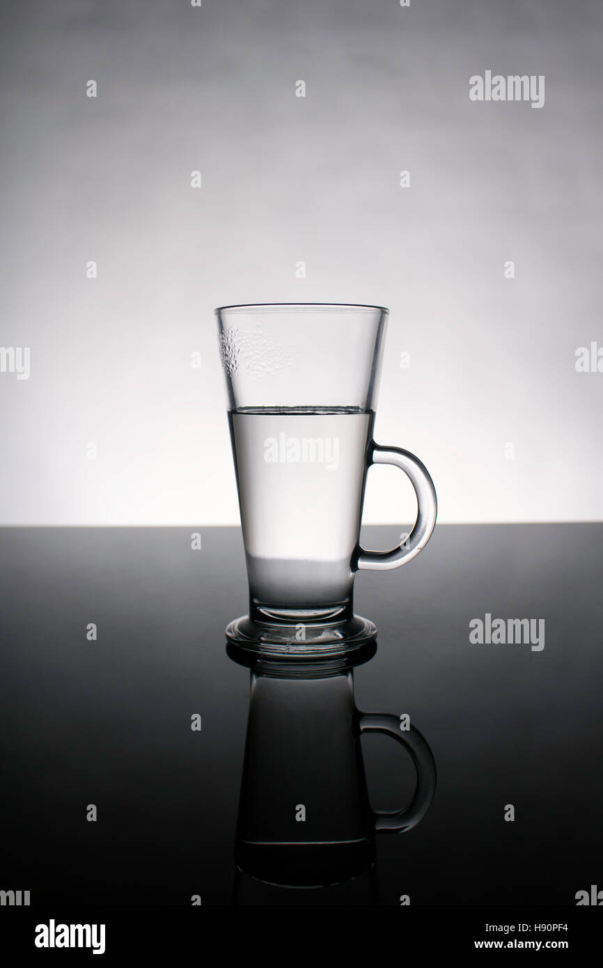 Commercial Mid Shot Studio Clear Glass Of Water With Reflection Stock Photo