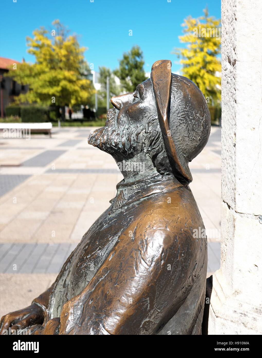 A bronze outdoor statue of a weary and tired pilgrim in San Marcos square along the Camino Frances in Leon, Spain. Stock Photo