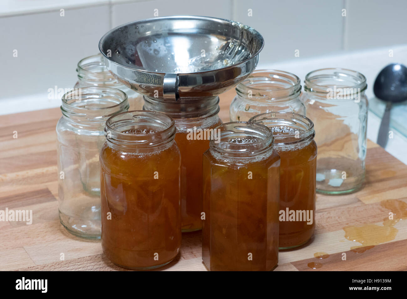 Putting marmalade in jars Stock Photo Alamy