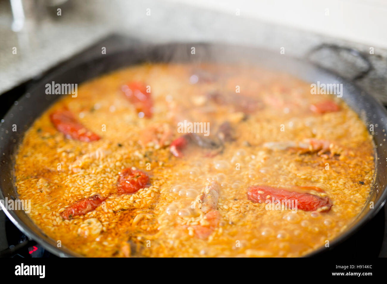 Paella cooking on an electric stove. Typical cuisine of the Valencian