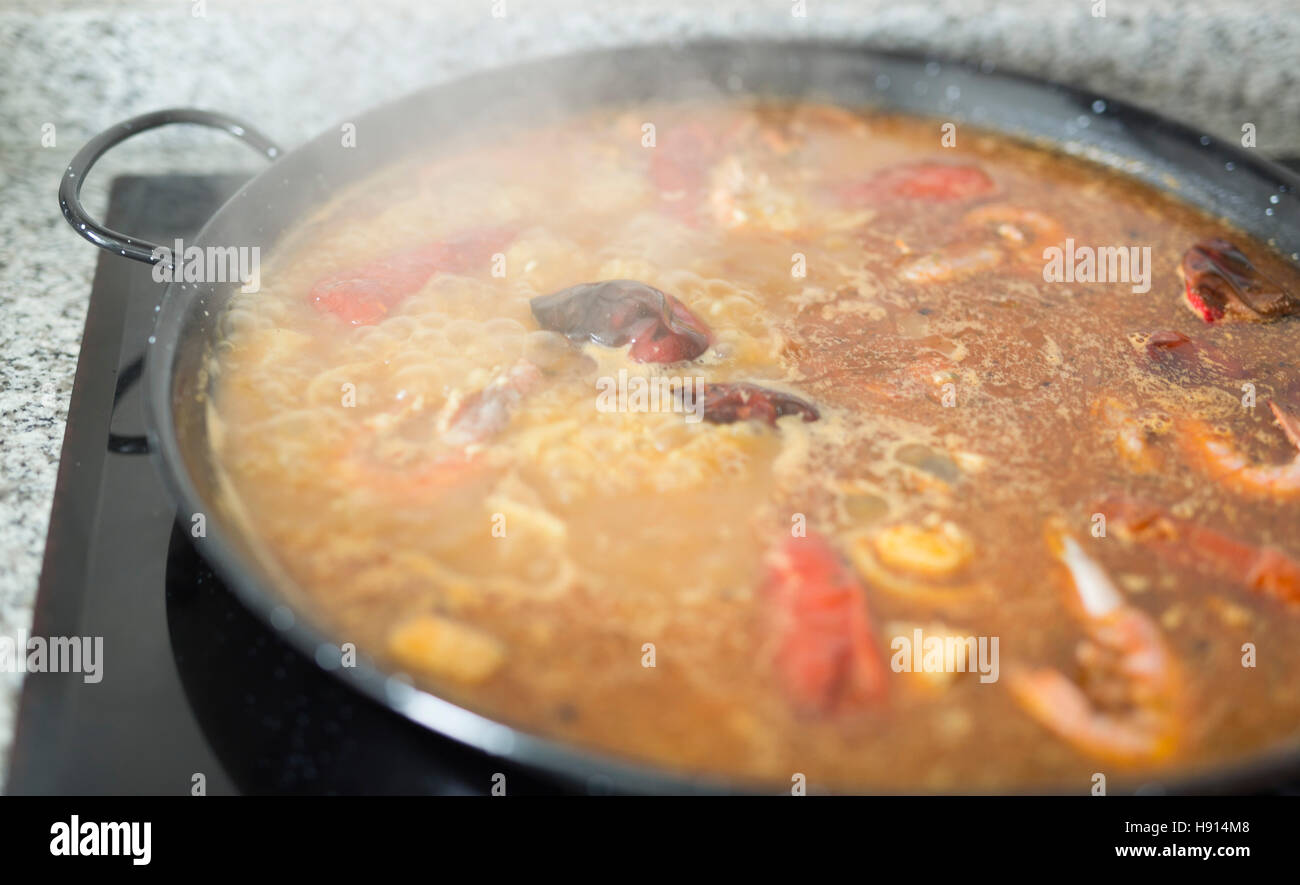 Paella cooking on an electric stove. Typical cuisine of the Valencian