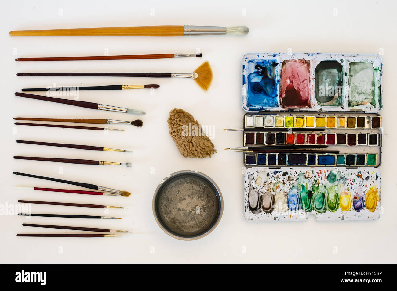 A still life with the water-colour artist tools on a white background. Stock Photo