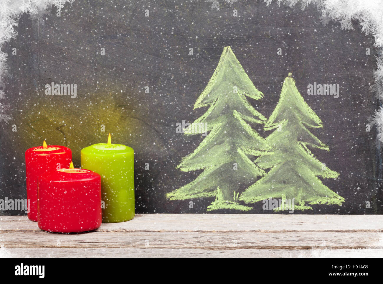 Christmas candles and hand drawn xmas fir tree with snow Stock Photo