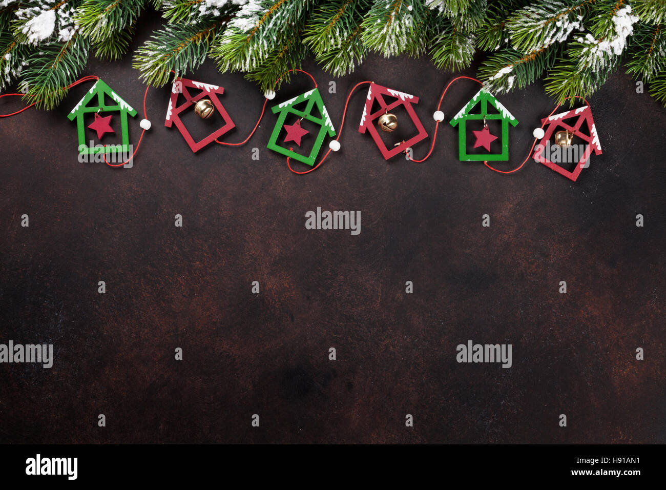 Christmas stone background with snow fir tree and decor. Top view with ...