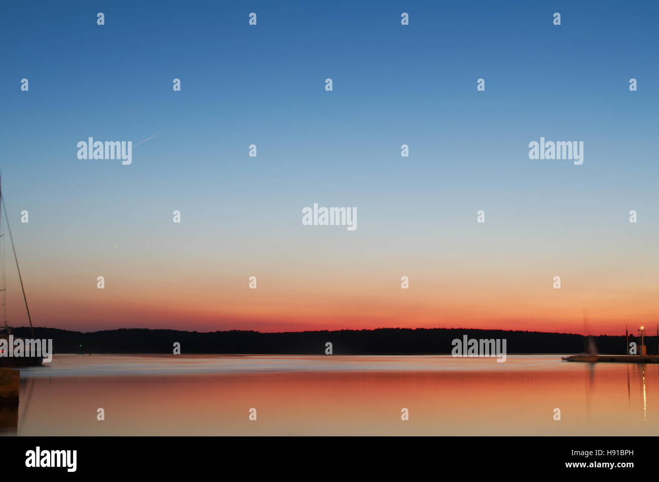 Orange Bay Seascape at Dusk with Clear Blue Sky Stock Photo