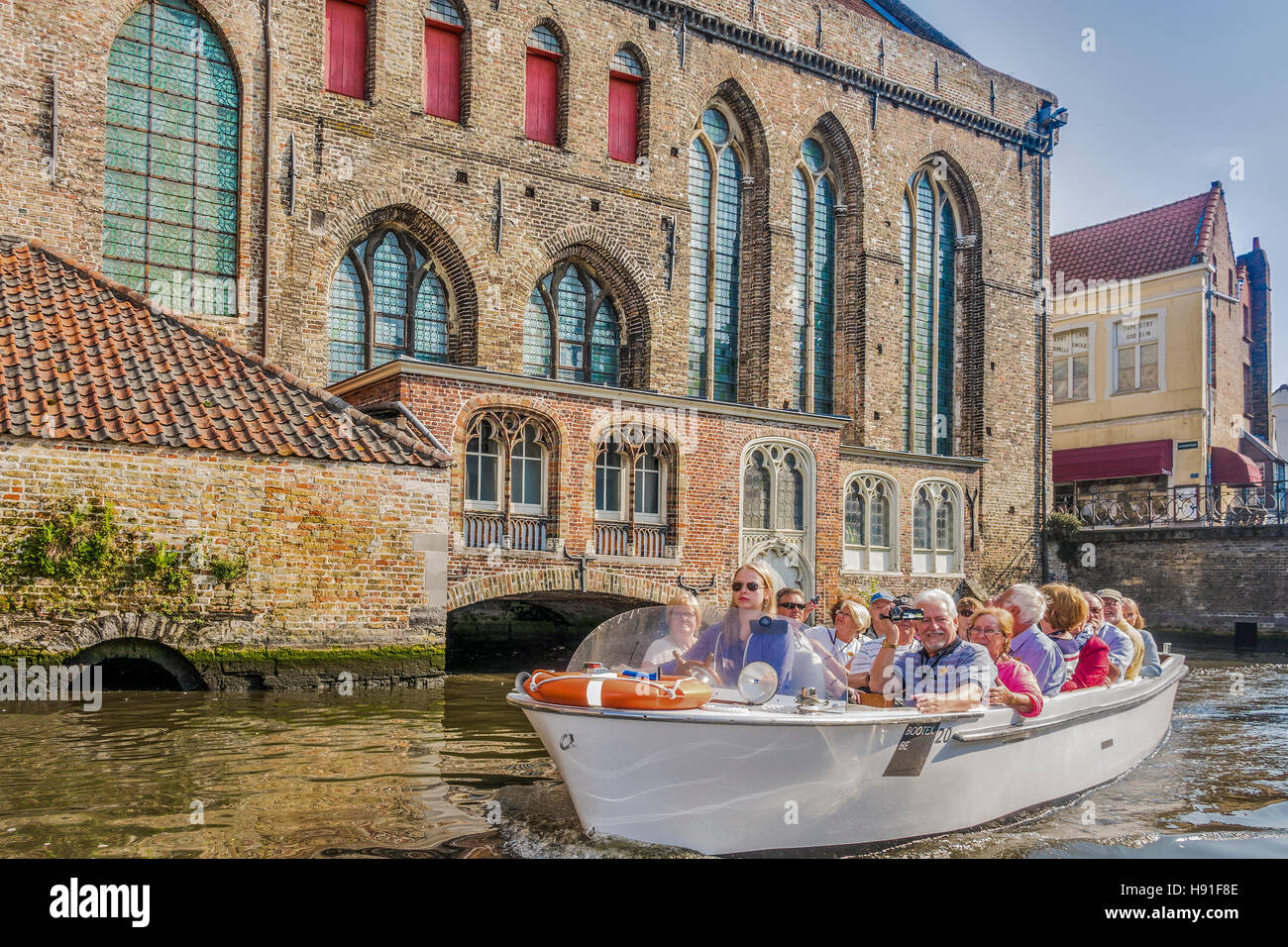 Tourist Boat Traveling Along The Canal Bruges Belgium Stock Photo