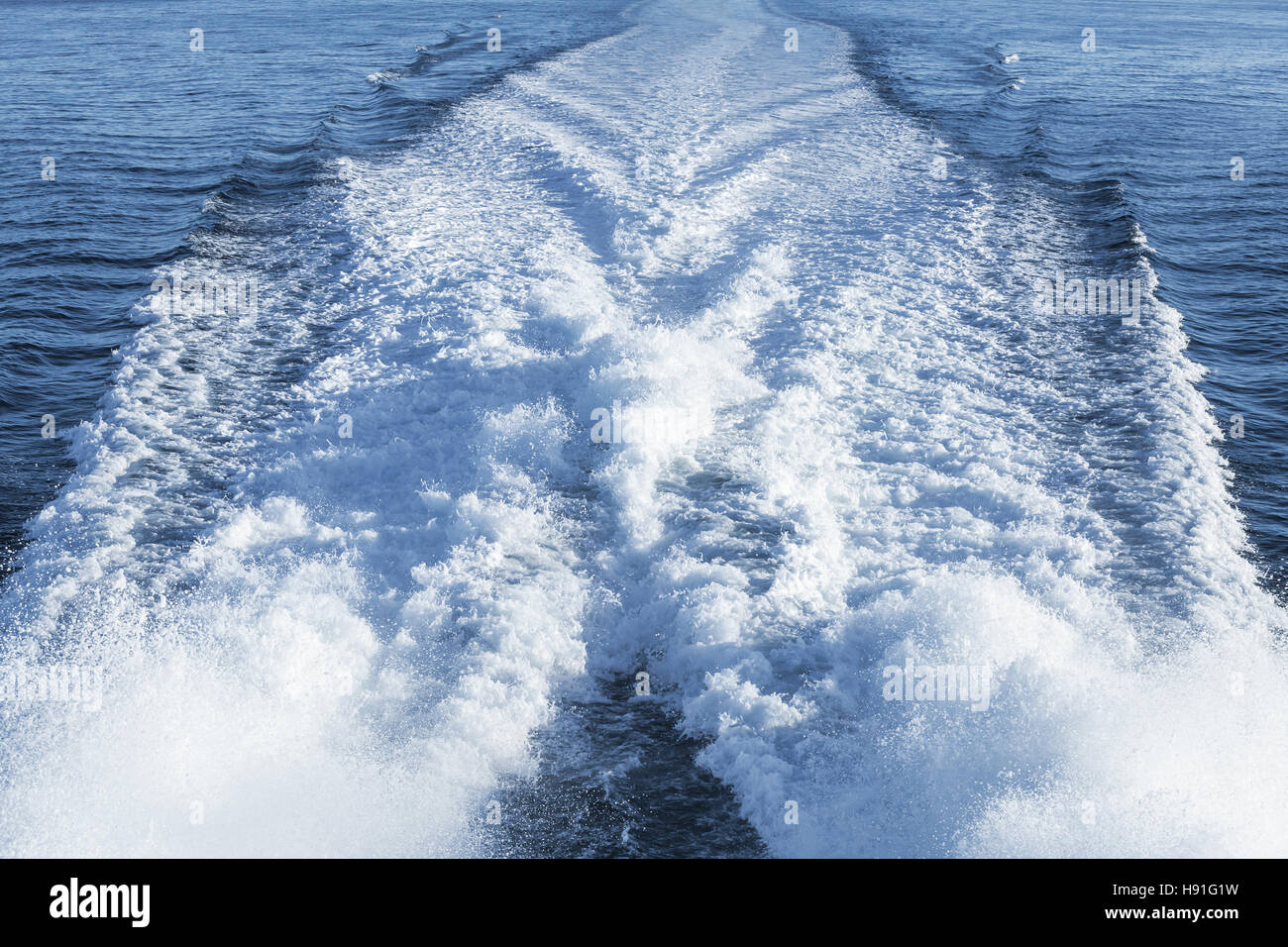 Fast motor boat wake over blue sea water Stock Photo