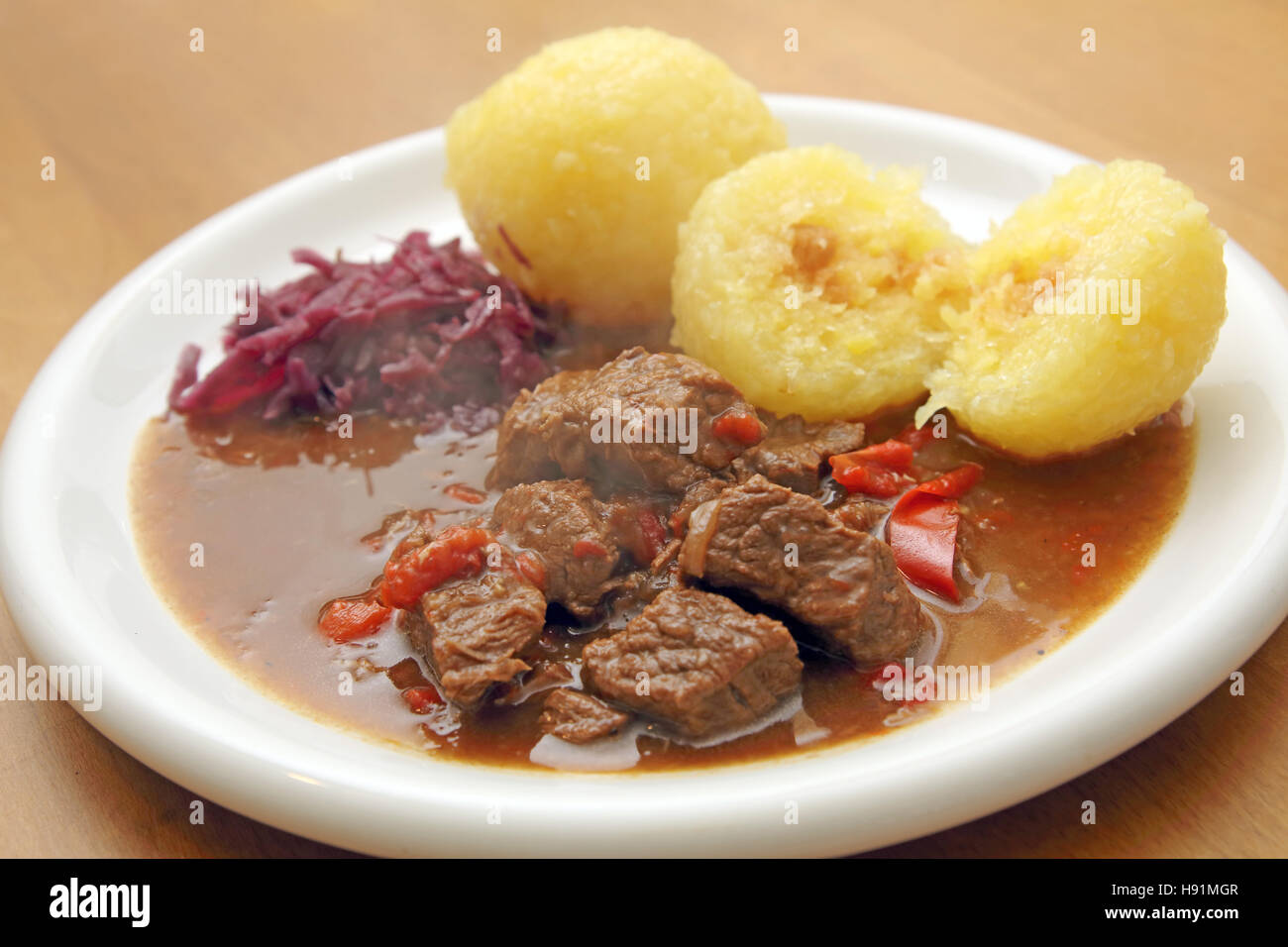 Goulash with dumplings and red cabbage Stock Photo Alamy
