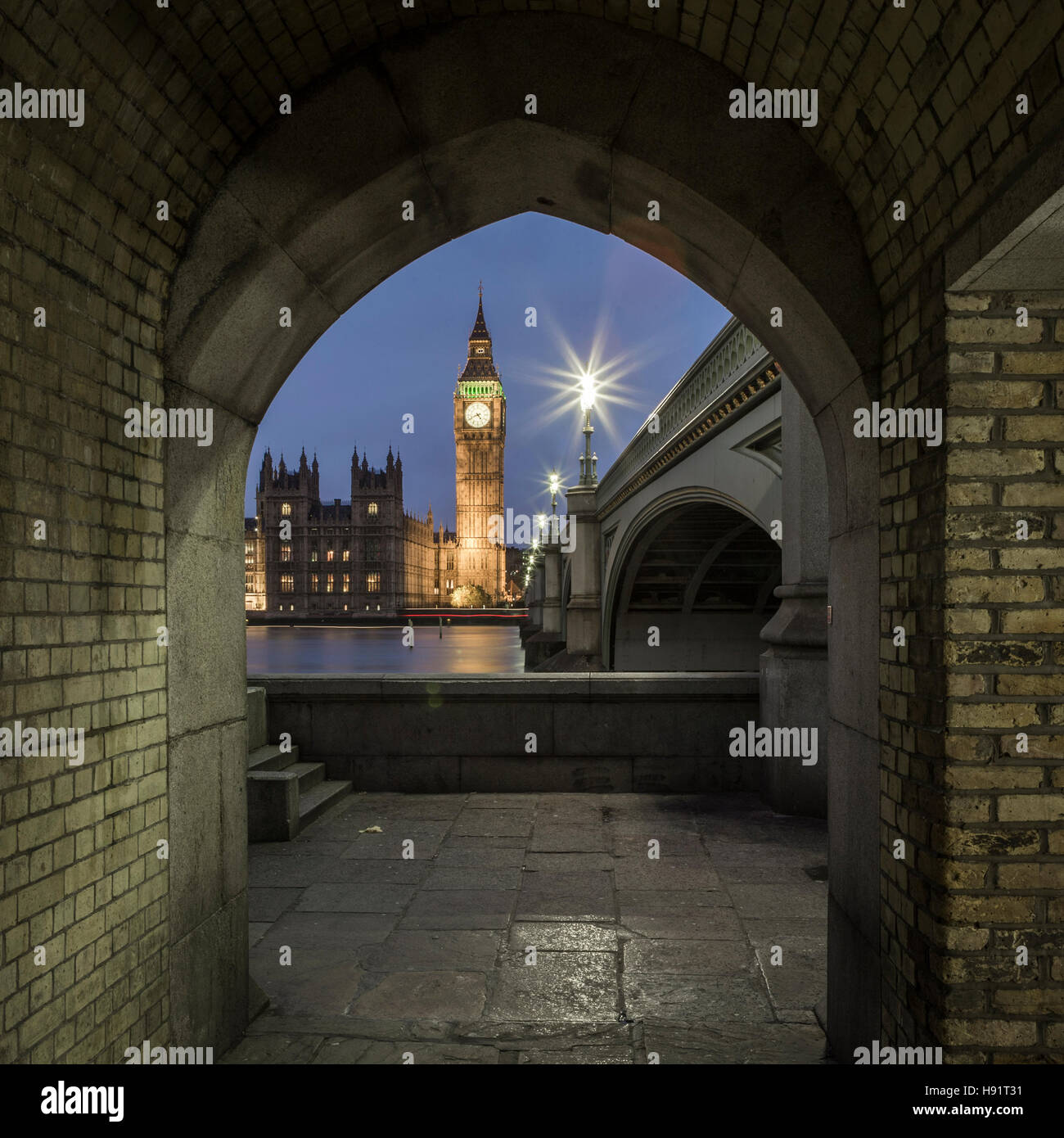 A view of Big Ben at night from across the River Thames from the riverside walkway opposite Elizabeth Tower. Stock Photo
