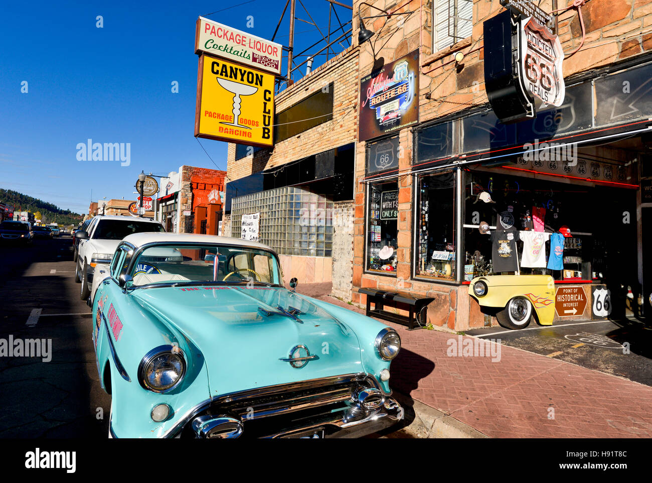 A street scene with an antique car in front of a souvenir shop on Route