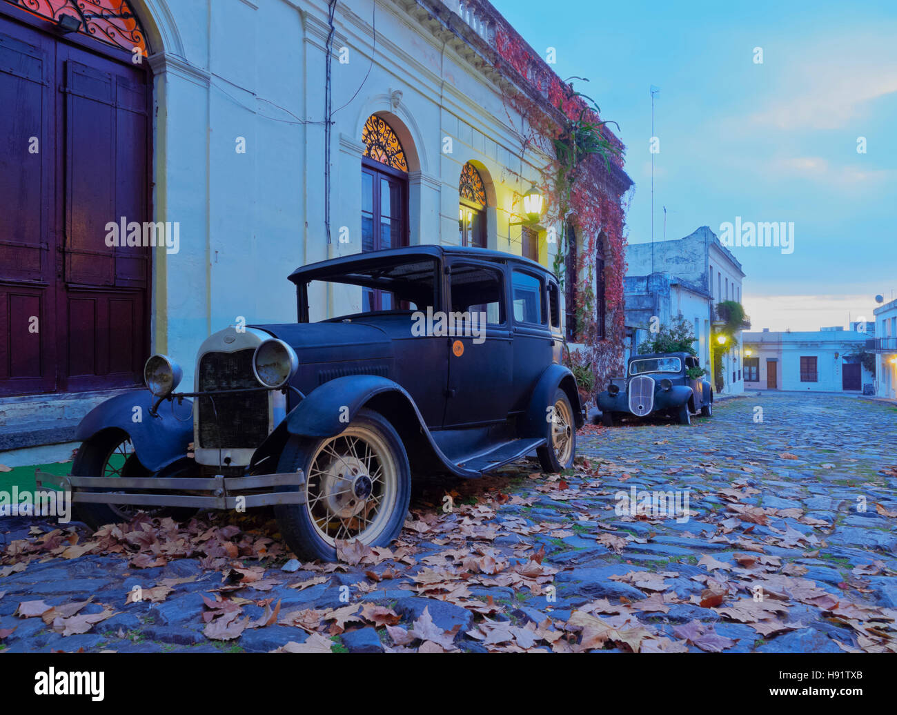 Uruguay, Colonia Department, Colonia del Sacramento, Vintage cars on the cobblestone lane of the historic quarter. Stock Photo