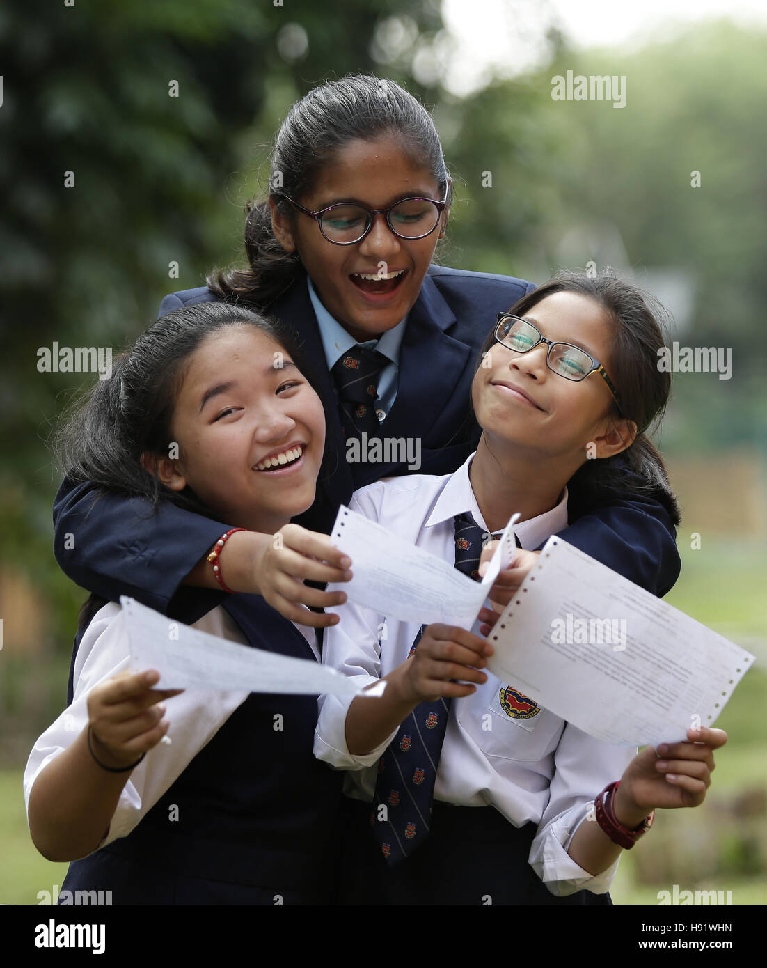 Kuala Lumpur, Malaysia. 17th Nov 2016. Multiracial elementary school students share the joy after achieving exam results. Stock Photo