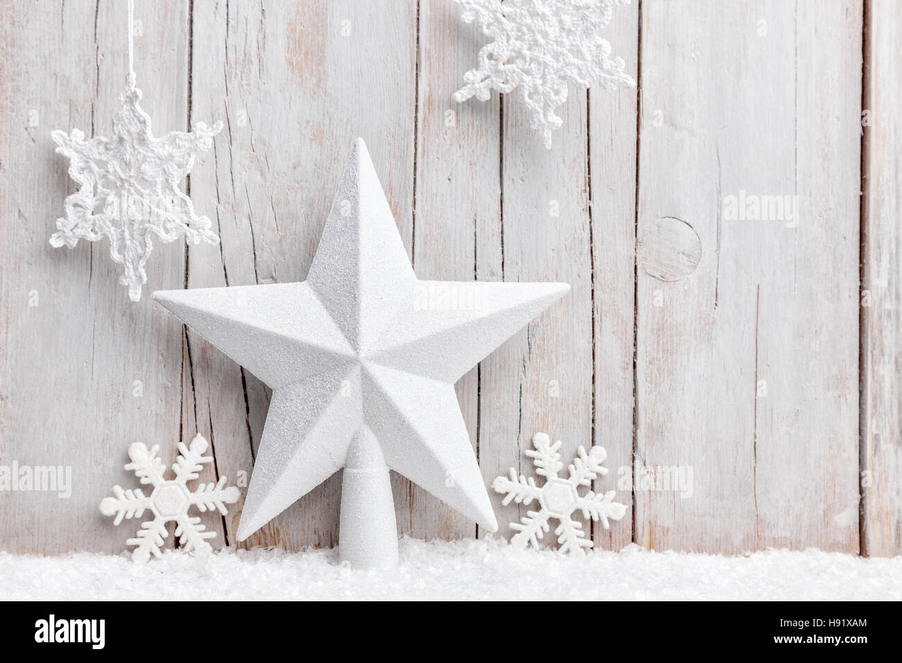Christmas star and snowflakes with snow on grey background Stock Photo