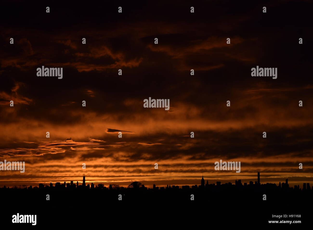 New York City skyline sunset orange landscape with dramatic clouds ...