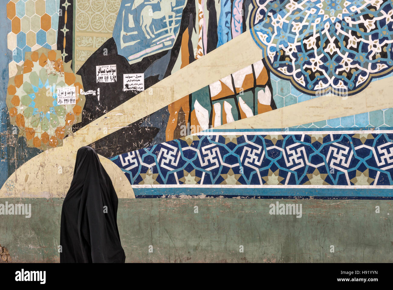 Grafiti and woman in chador Shiraz Iran Stock Photo