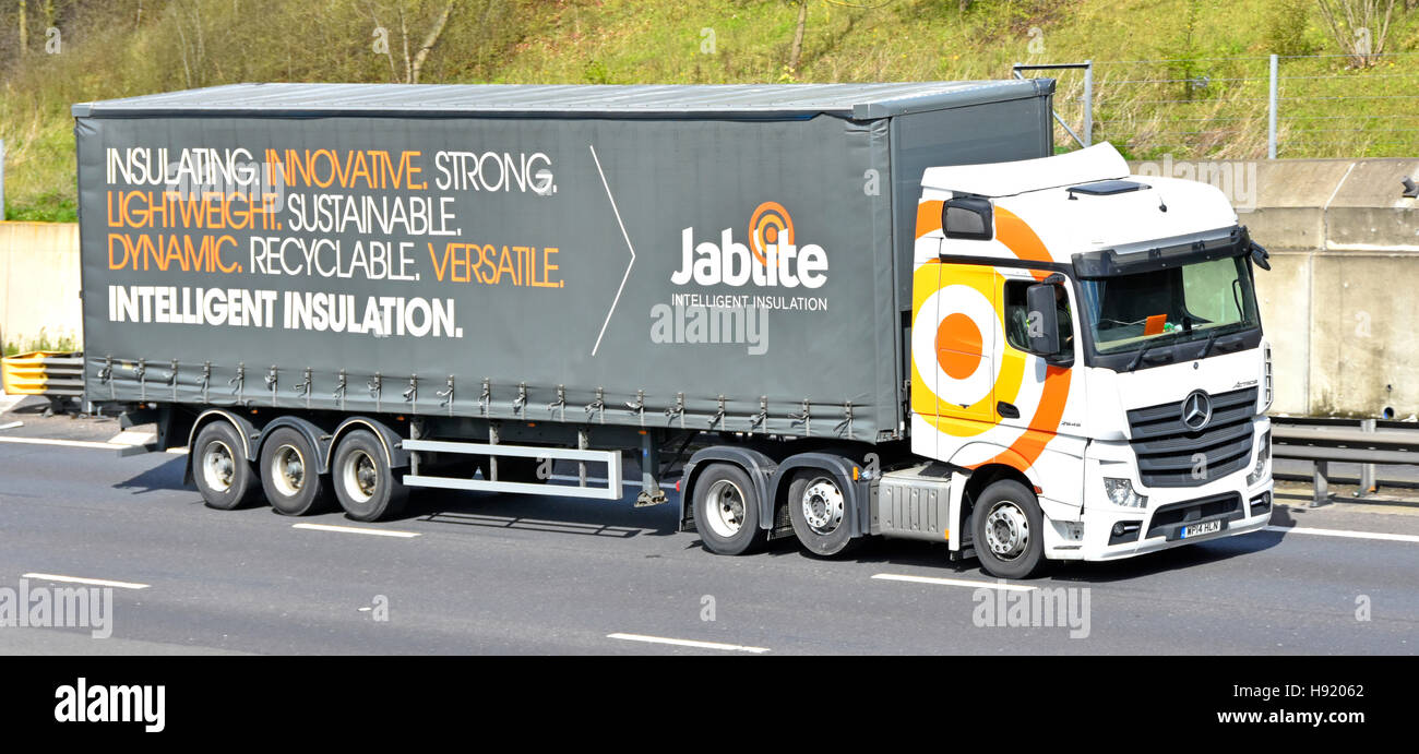 Side & front of large articulated hgv delivery lorry & long trailer for Jablite brand lightweight insulation materials UK m25 motorway truck logistics Stock Photo
