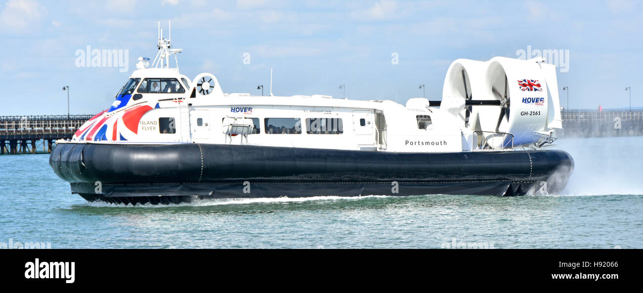 Solent side view close up Hovercraft GH-2161 'Island Flyer' public transport flight arriving Ryde Isle of Wight uk crew & passengers Ryde Pier beyond Stock Photo