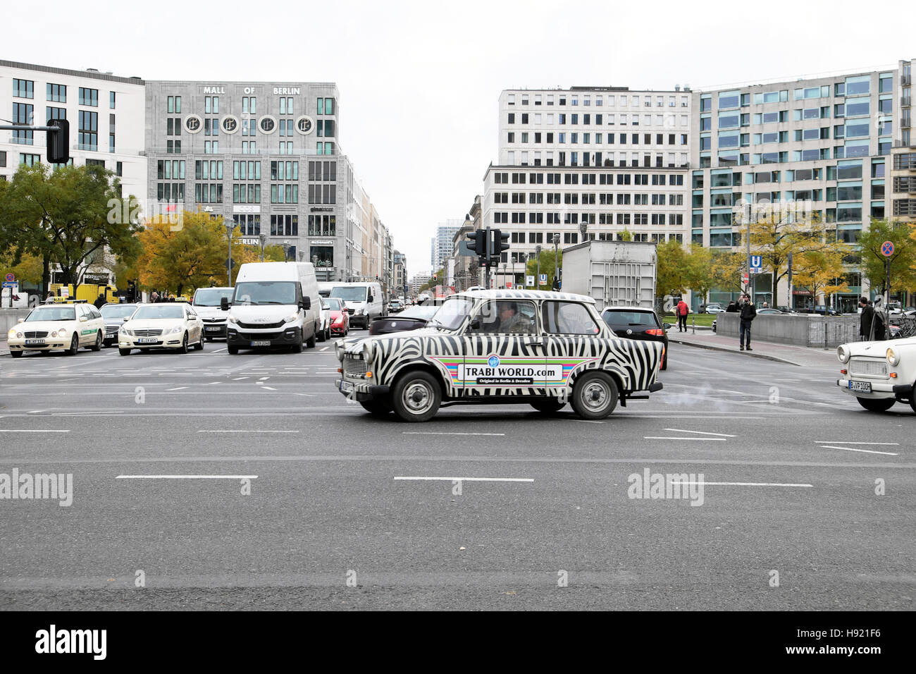Berlin street scene with a Trabi World tour Trabant  East German car in traffic at Potsdamer Platz, Berlin, Germany, EU  KATHY DEWITT Stock Photo
