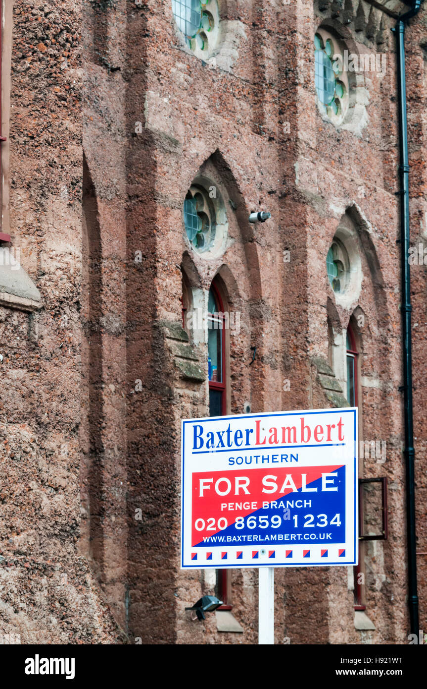For Sale sign outside concrete New Church in Anerley, South London. Built in concrete using Portland cement & pink dye in 1883. Stock Photo