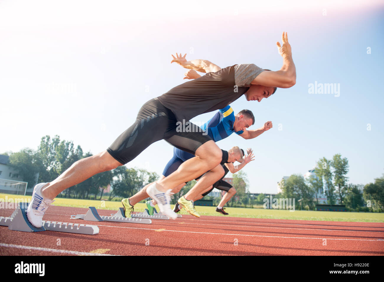 Runners preparing for race at starting blocks Stock Photo Alamy