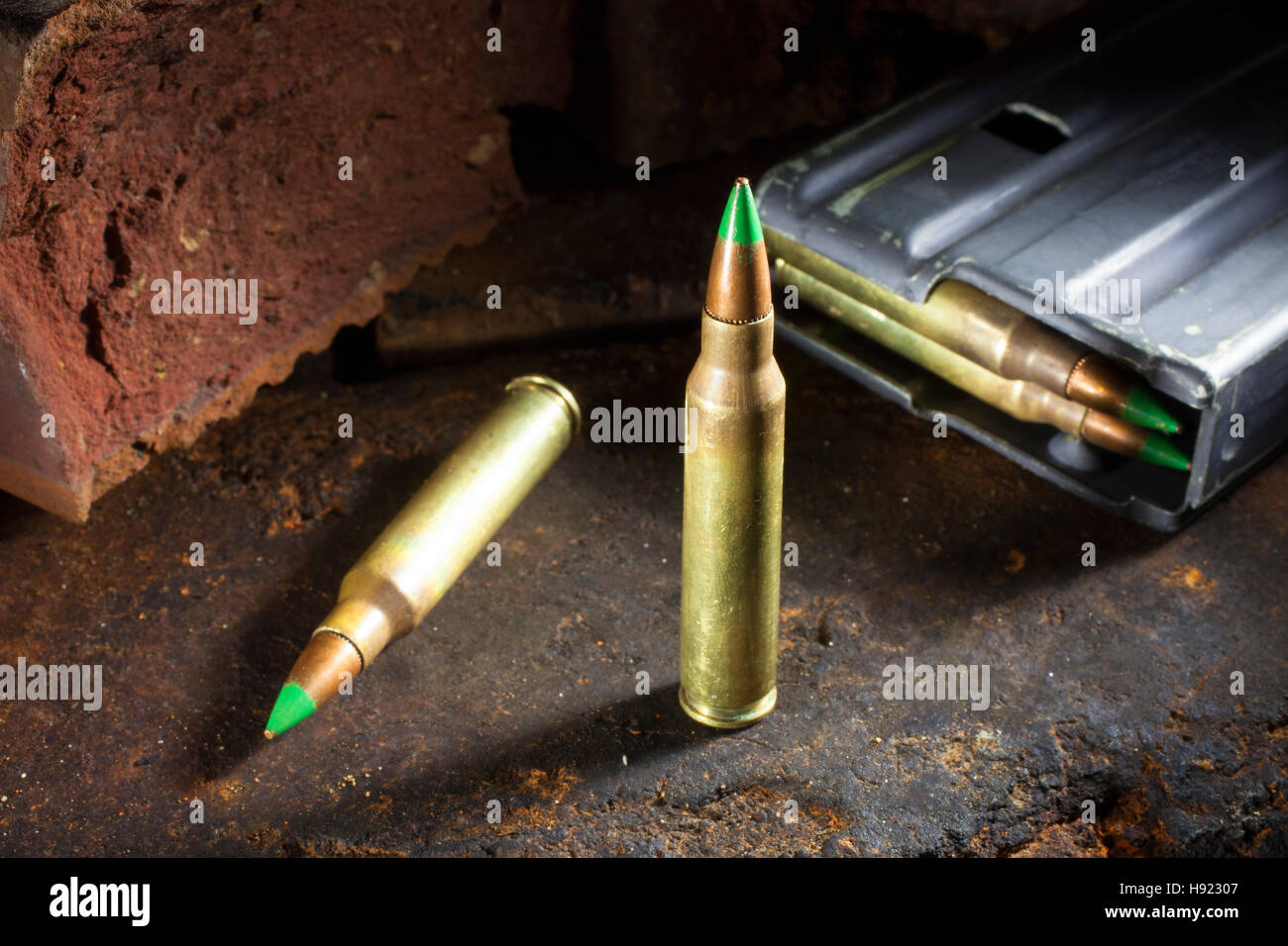 Small rifle ammo with green tips and a loaded magazine behind Stock ...