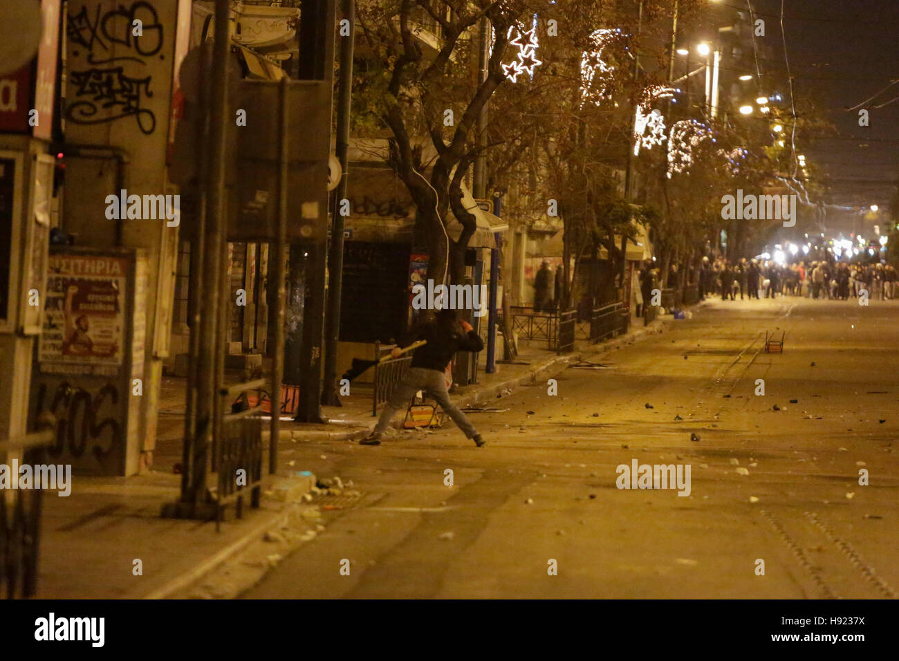 Athens, Greece. 17th Nov, 2016. A protester throws stones at the police. The protest march from the Athens Polytechnic to the US embassy that is held as part of the 1973 Athens Polytechnic uprising commemoration turnt violent, when protesters who barricaded themselves inside the Polytechnic attacked riot police officers with stones and petrol bombs. © Michael Debets/Pacific Press/Alamy Live News Stock Photo