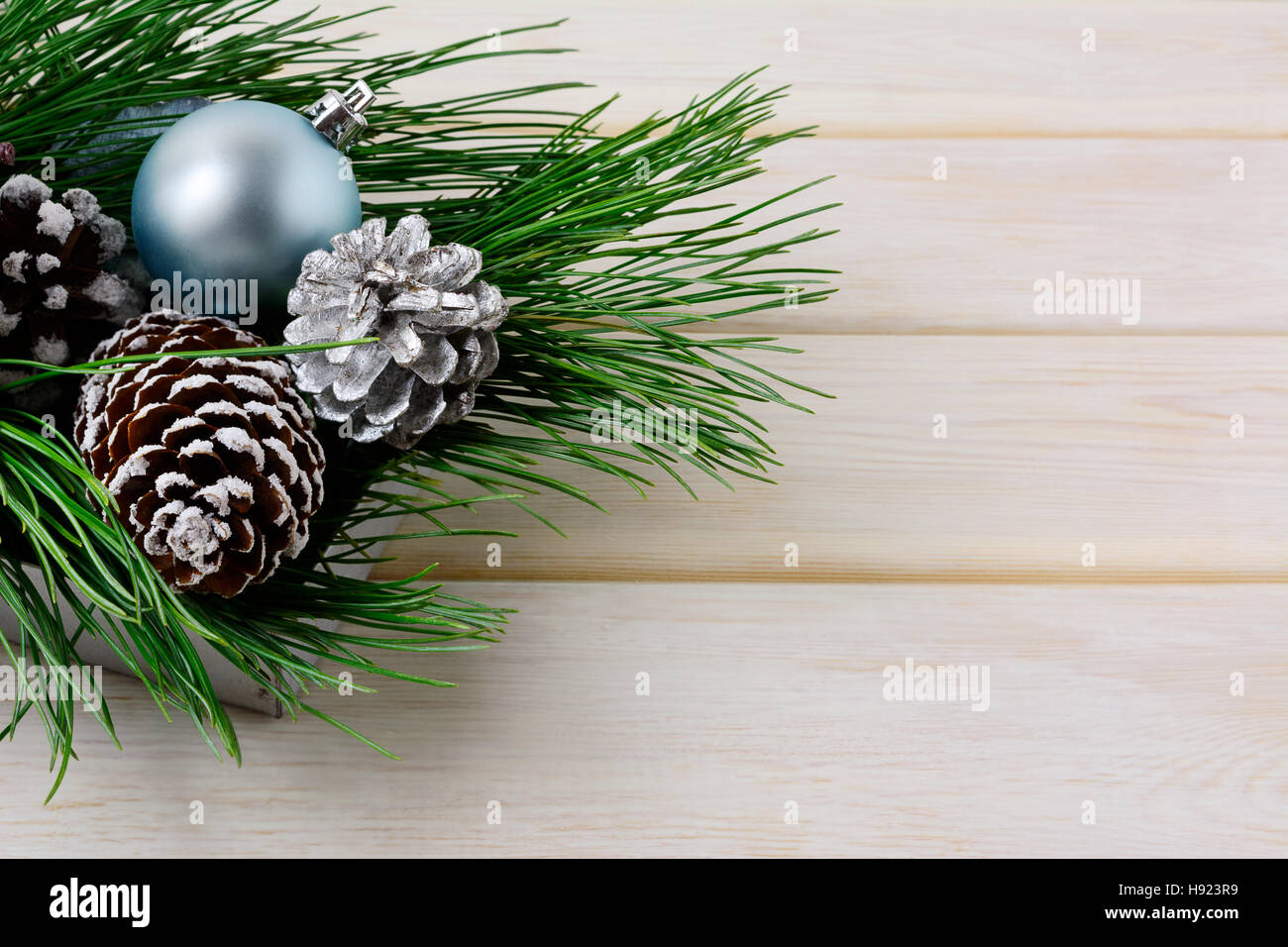 Christmas background with blue ornaments, silver and snowy pinecones. Christmas table decorated centerpiece. Copy space. Stock Photo