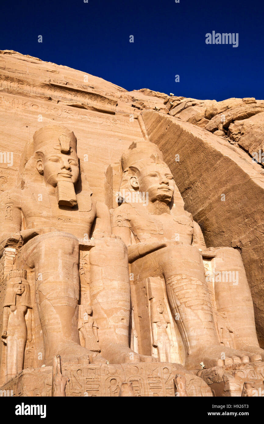 Statues of pharaoh Ramesses II wearing the double Atef crown of Upper and Lower Egypt at Abu Simbel. Stock Photo