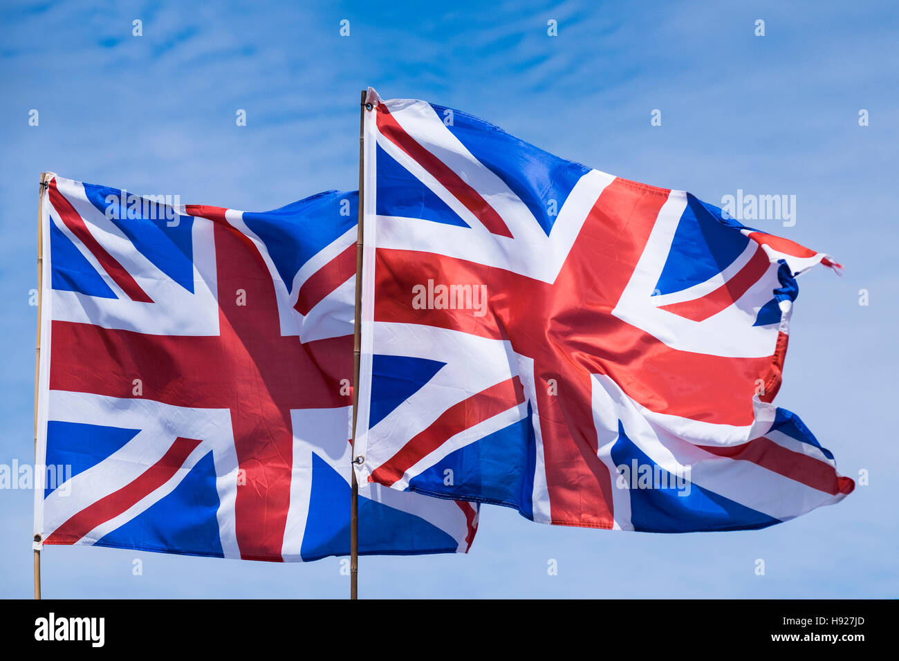 Two Union flags flying against a blue sky Stock Photo - Alamy