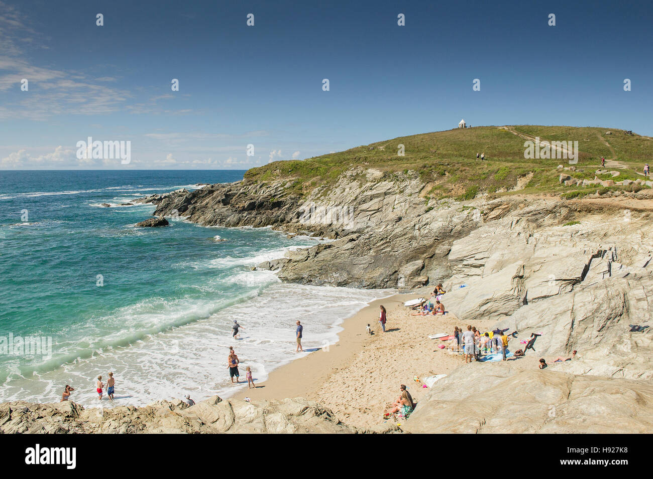 Holidaymakers enjoy the summer weather on a beach on The Headland in Newquay in Cornwall. Stock Photo