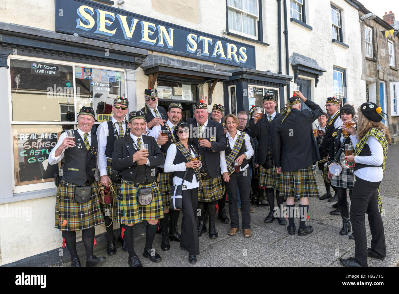 Members of the Falmouth Marine Band take a welcome break for refreshment during the Penryn Festival in Cornwall. Stock Photo