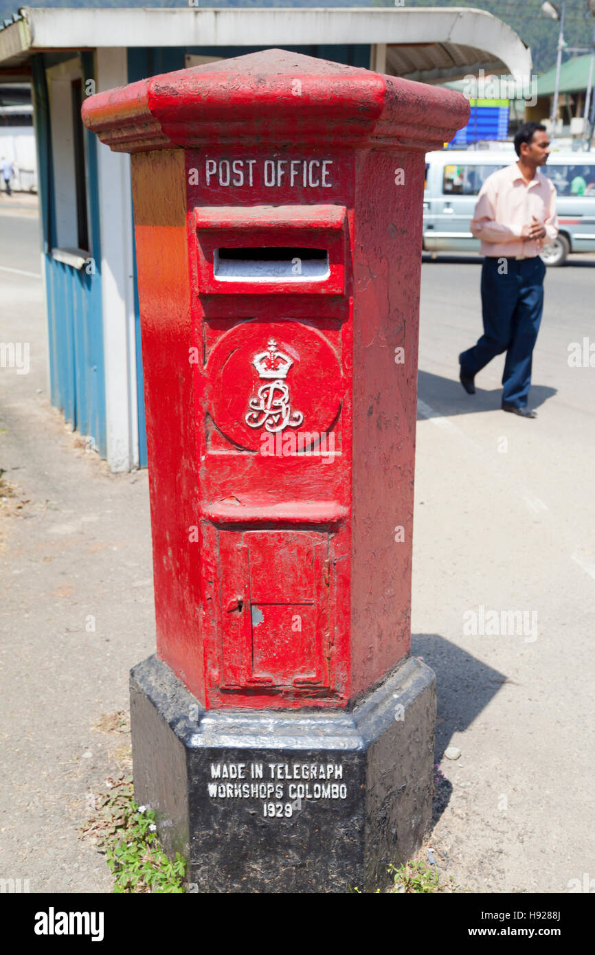 An original 1929 antique red post box with George V insignia in a small town outside Kandy in Sri Lanka. Stock Photo