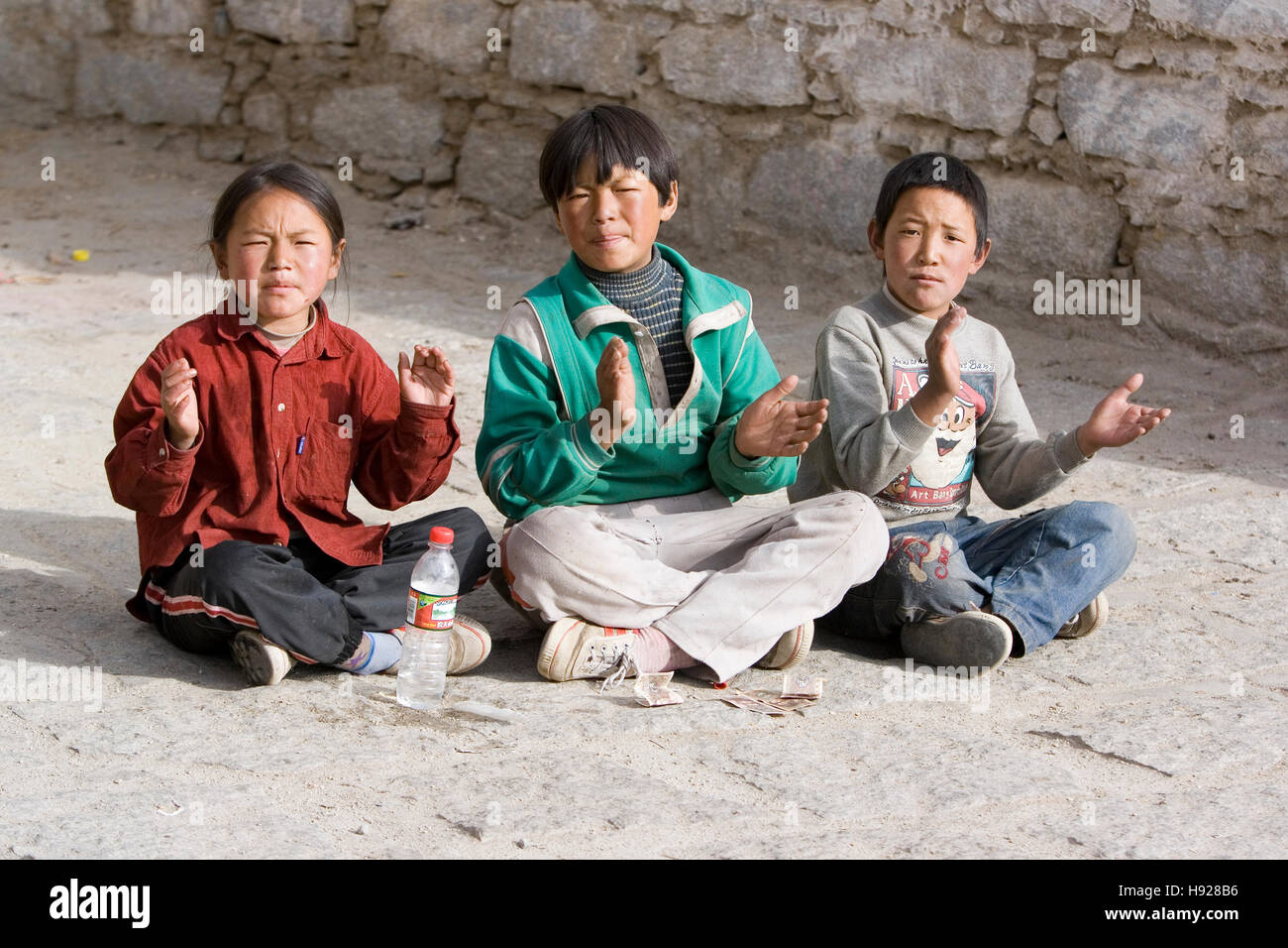 Three children at the Drepung Monastery Lhasa in Tibet. Stock Photo
