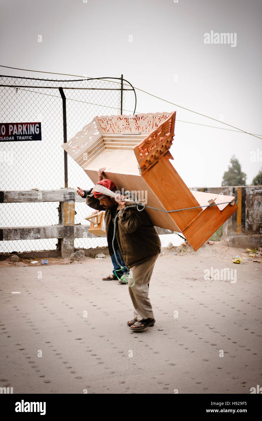 Man carrying a cabinet in Darjeeling. Stock Photo