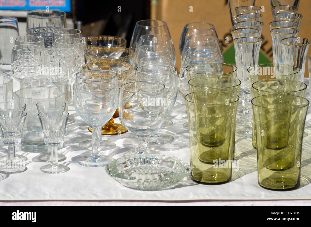 Different glassware on display at second hand market, Spain Stock Photo