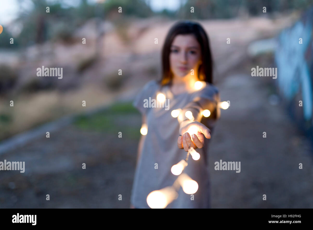 teenager with lights focused hands and face and body is out of focus. Stock Photo