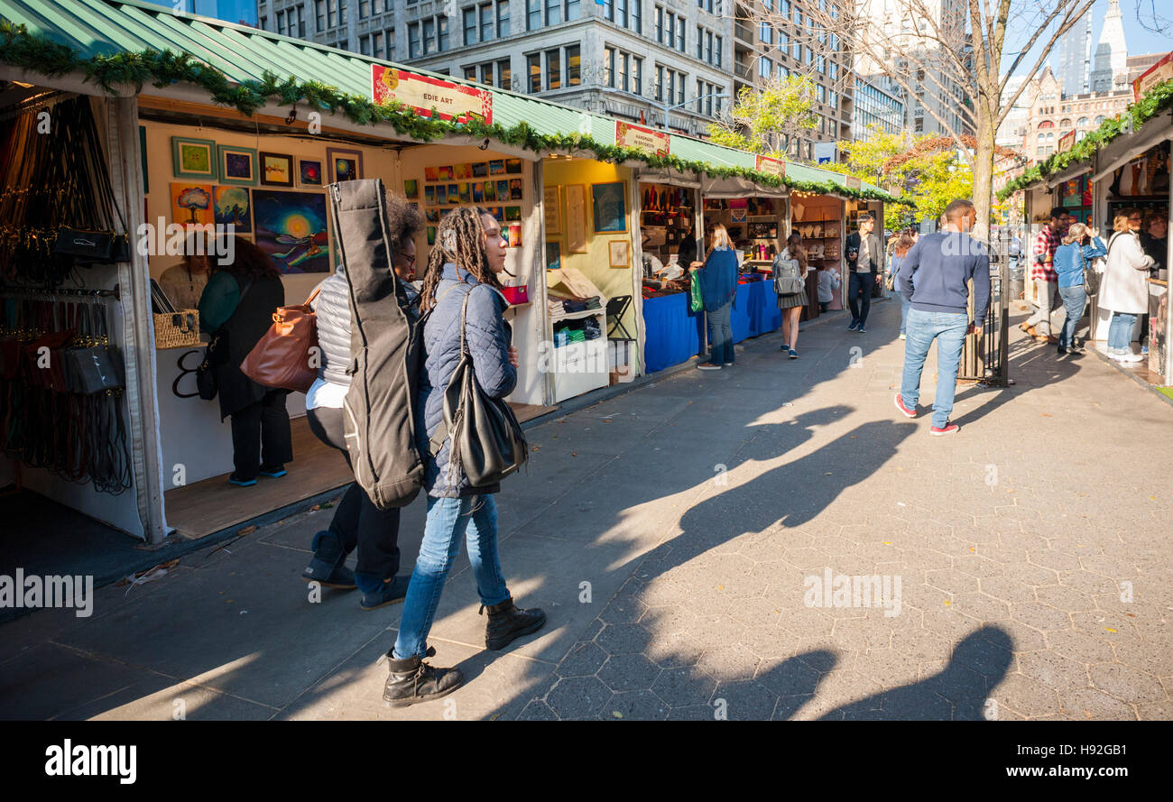 Shoppers browse the Union Square Holiday Market in New York on opening day, Thursday, November 17, 2016. Over 100 vendors sell their holiday wares at the market which includes 'Lil' Brooklyn' and 'UrbanSpace Provisions' sections. Now in it's 23rd year, the market will remain open daily, closing on December 24.  (© Richard B. Levine) Stock Photo