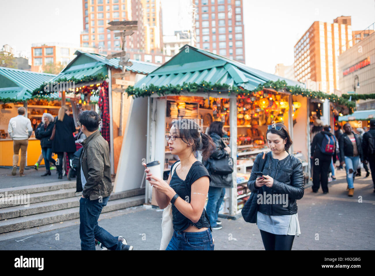 Shoppers browse the Union Square Holiday Market in New York on opening day, Thursday, November 17, 2016. Over 100 vendors sell their holiday wares at the market which includes 'Lil' Brooklyn' and 'UrbanSpace Provisions' sections. Now in it's 23rd year, the market will remain open daily, closing on December 24.  (© Richard B. Levine) Stock Photo