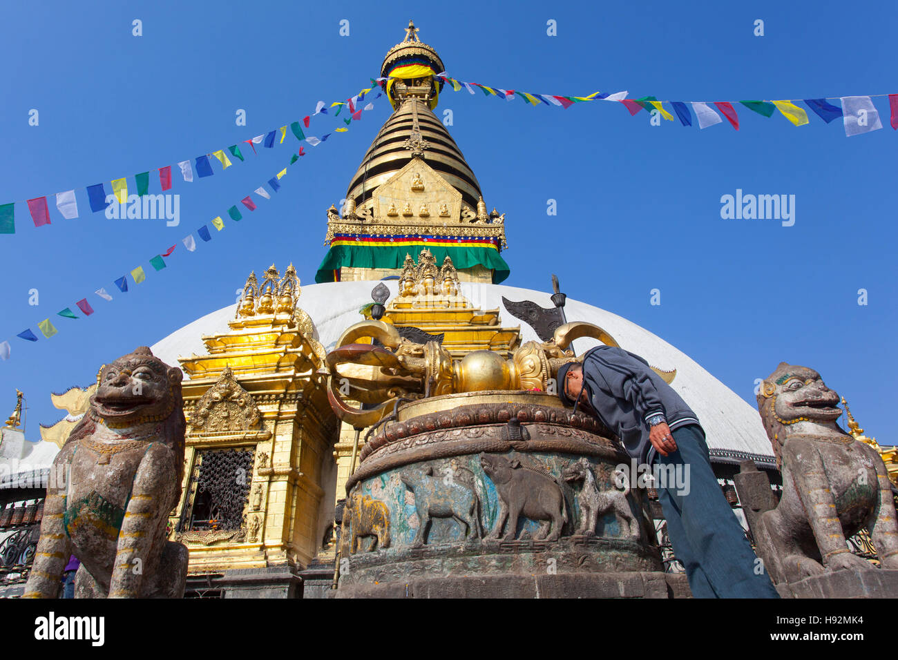 A man praying at the stupa of Swayambhunath, also known as Monkey Temple. Kathmandu, Nepal. Stock Photo