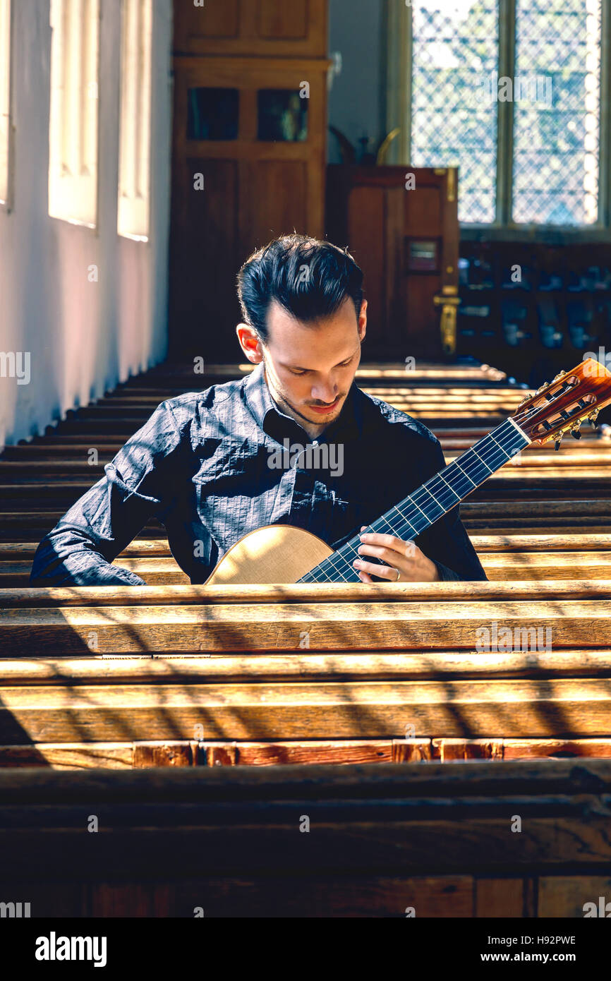 Young male classical musician with a guitar Stock Photo