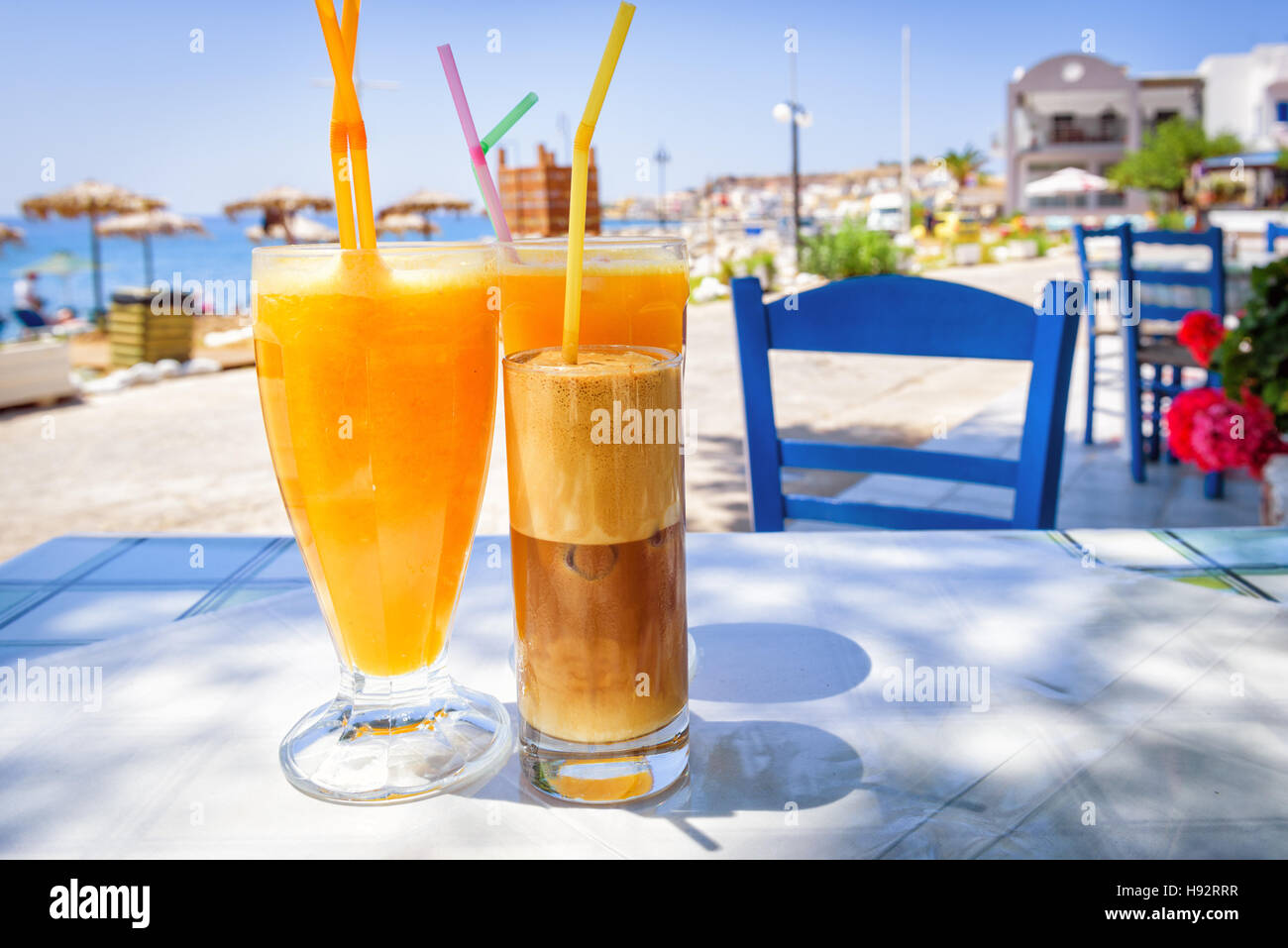 Glasses with orange juice and greek coffee frappe Stock Photo