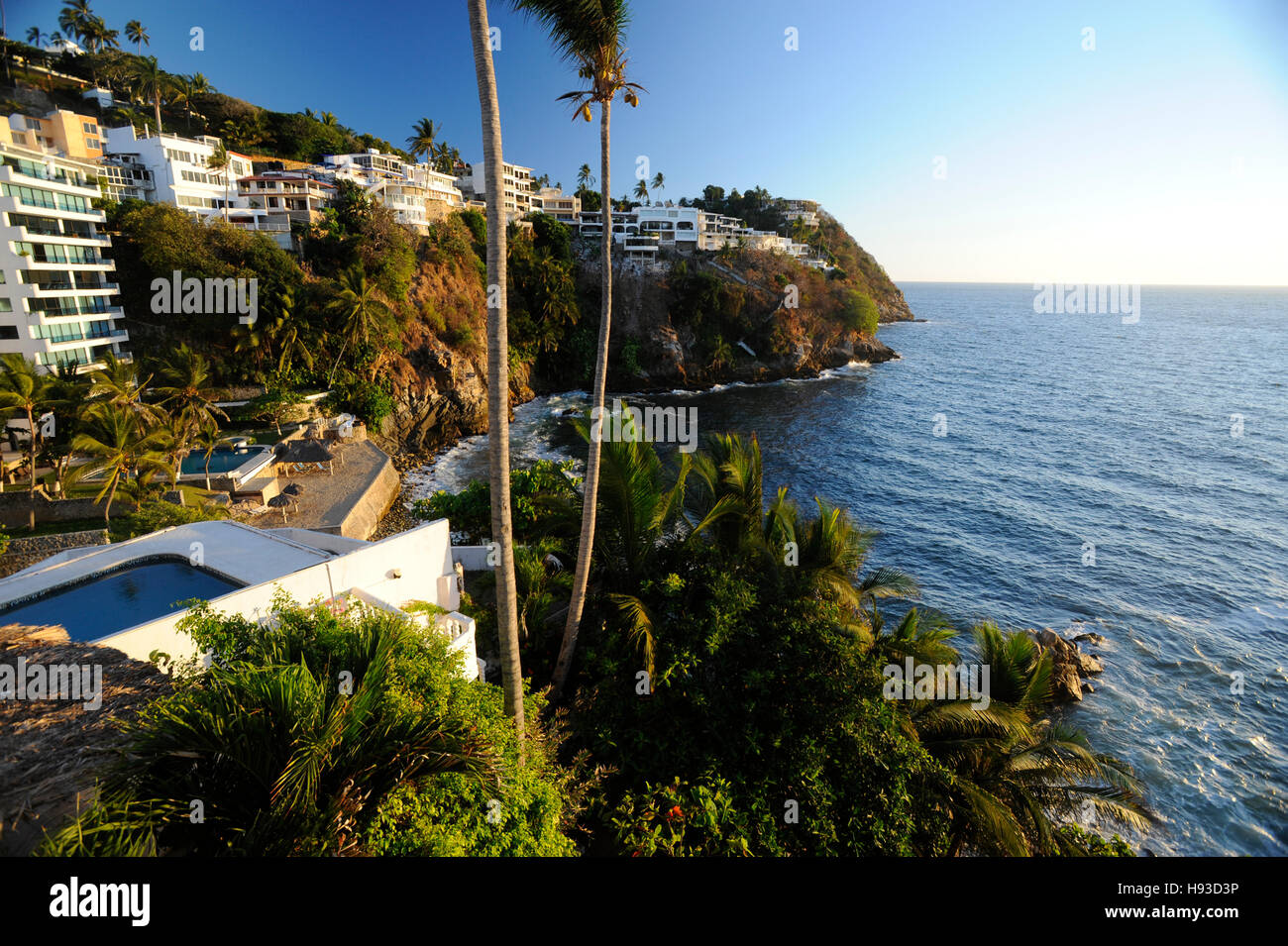 Coastal homes and apartments on cliffs above Pacific Ocean in Acapulco, Mexico. Property released. Stock Photo