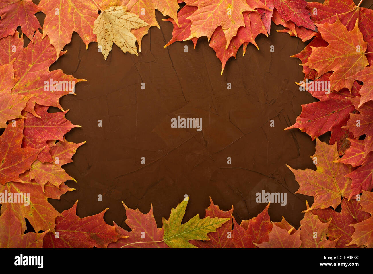 Fall leaves frame on brown background Stock Photo