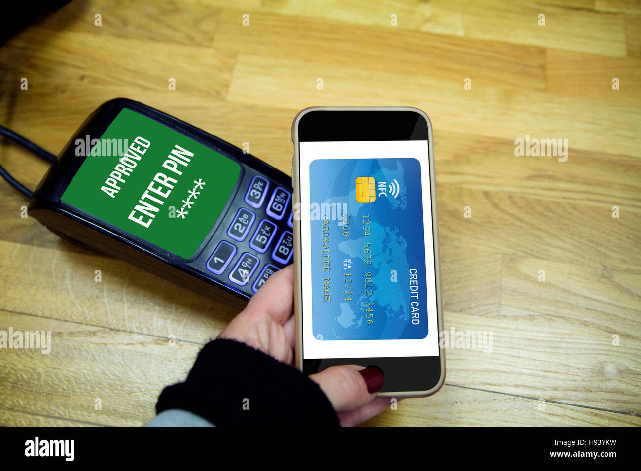 Woman making payment through smartphone via NFC contactless technology. All the graphics are made up. Stock Photo
