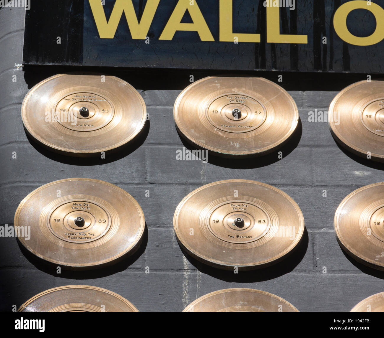 Small section of the Liverpool wall of fame, Mathew Street, bronze discs commemorating number one records by Liverpool artists. Stock Photo