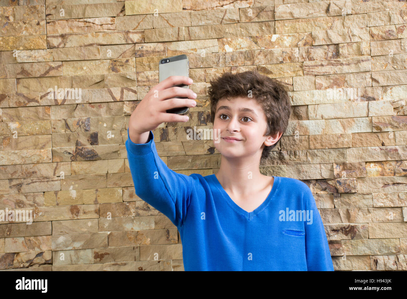 10 years old boy taking a selfie picture using a mobile phone camera Stock Photo Alamy